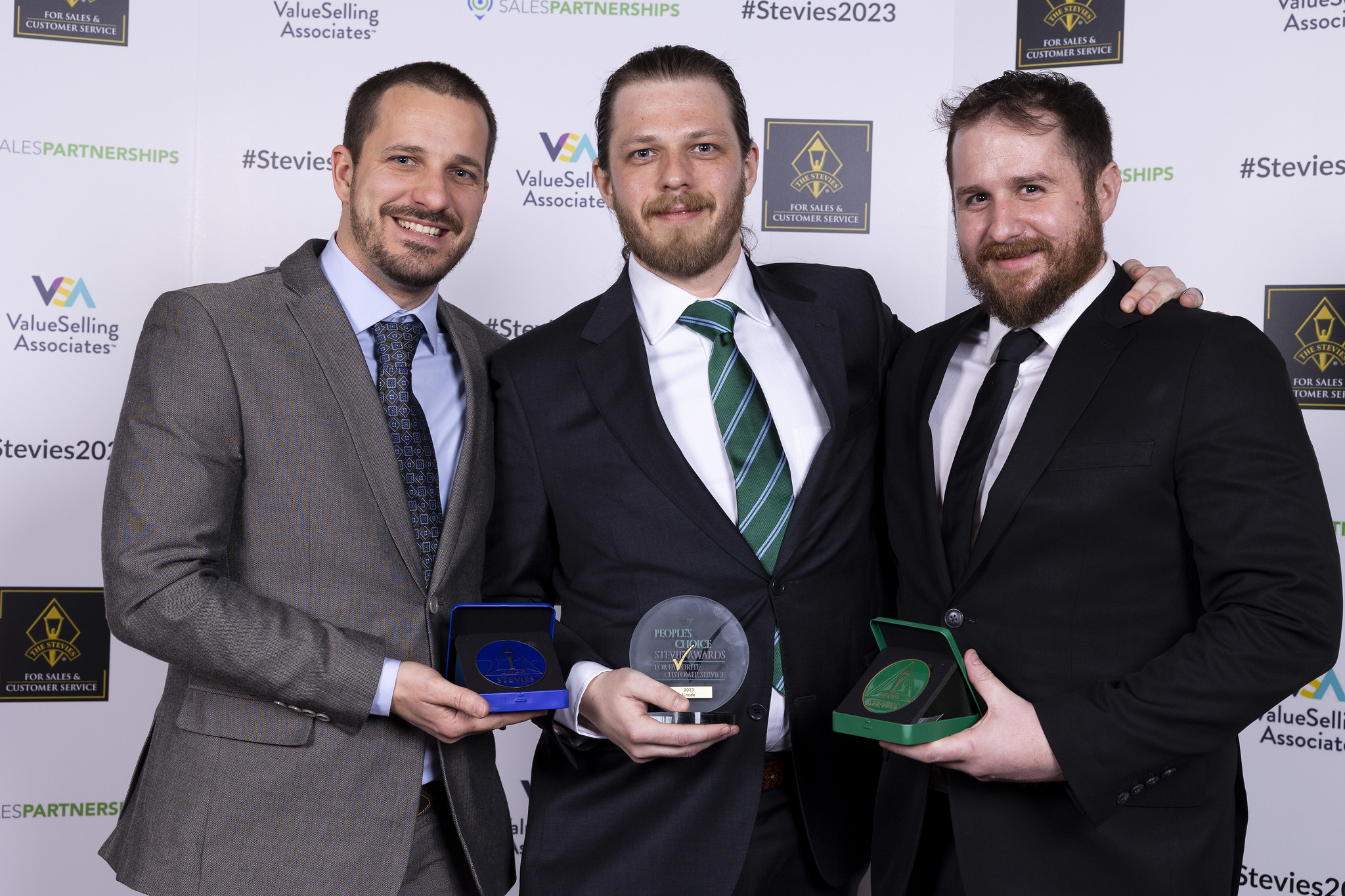 Ryan, Tim, and Mike with 2022's awards at the award ceremony in Las Vegas.